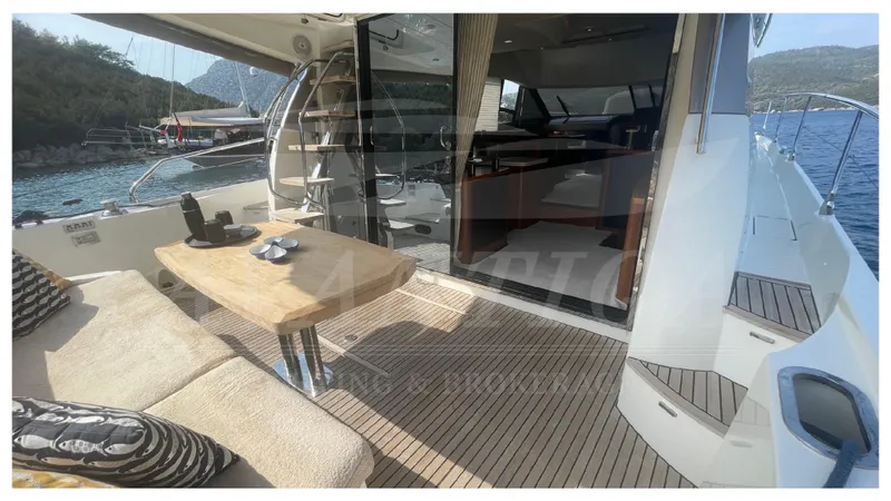  Yacht Photos Pics Luxurious 2012 Prestige 500 yacht interior with seating, table, and scenic ocean view.
