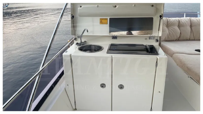  Yacht Photos Pics Outdoor kitchenette on a 2012 Prestige 500 yacht with sink and stove.