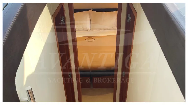  Yacht Photos Pics Interior view of a 2012 Prestige 500 yacht cabin with a cozy bed.