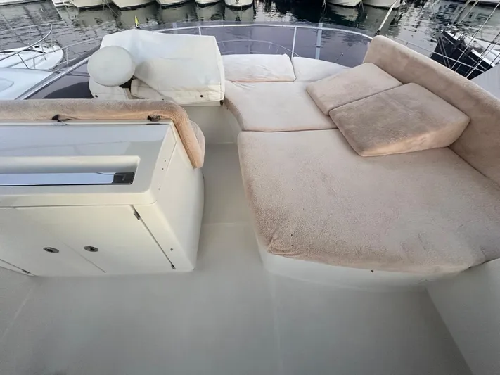  Yacht Photos Pics Luxurious seating area on a 2012 Prestige 500 yacht, docked at a marina.