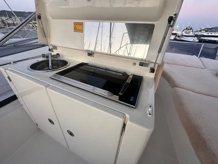  Yacht Photos Pics Outdoor kitchenette on 2012 Prestige 500 yacht with sink and stove.
