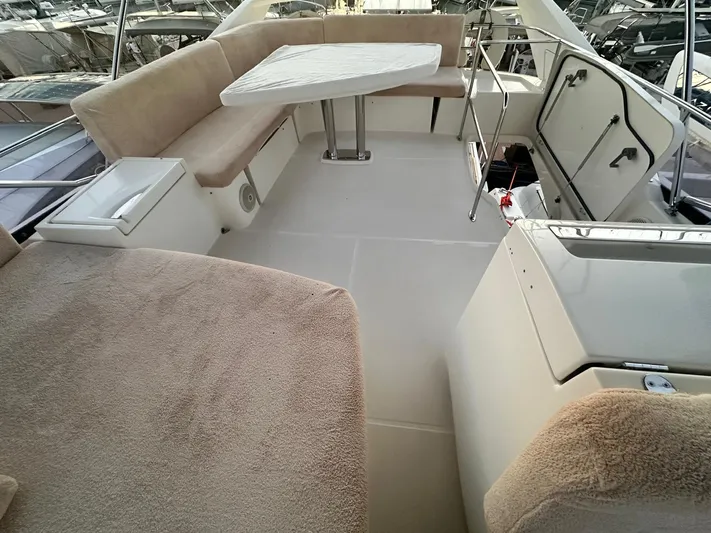  Yacht Photos Pics Luxurious seating area on a 2012 Prestige 500 yacht with a table and plush cushions.