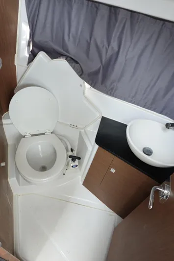  Yacht Photos Pics 2021 Jeanneau NC 895 boat bathroom with toilet, sink, and curtain.