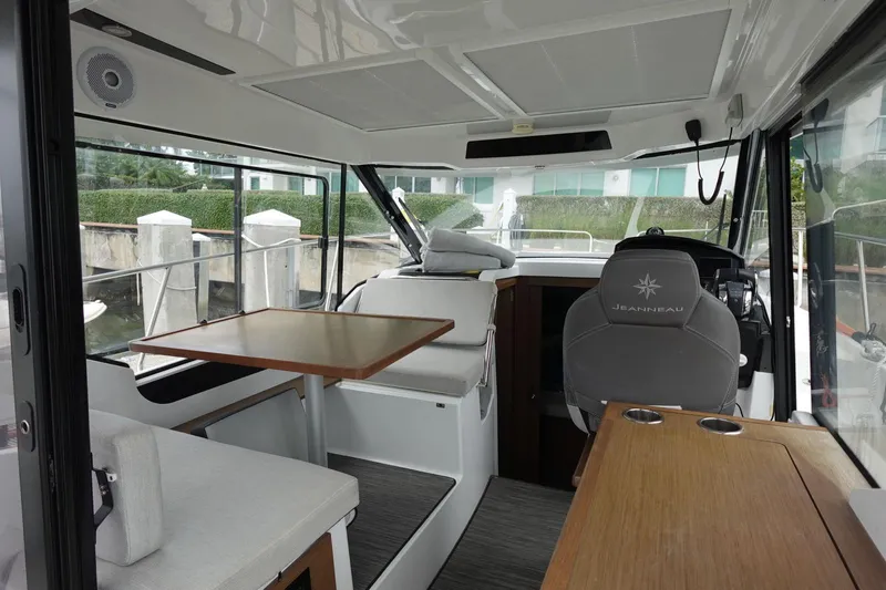  Yacht Photos Pics Interior of 2021 Jeanneau NC 895 boat, featuring seating and helm station.