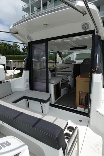  Yacht Photos Pics 2021 Jeanneau NC 895 boat interior with seating and cabin view.