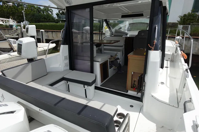  Yacht Photos Pics 2021 Jeanneau NC 895 boat interior with seating and helm station.