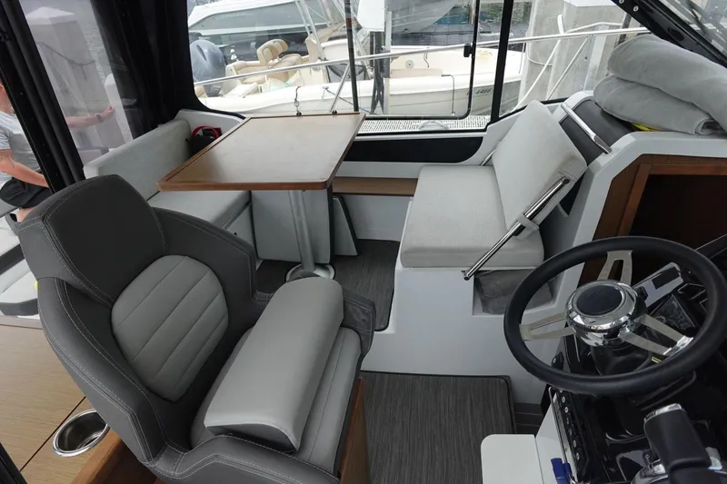  Yacht Photos Pics Interior of 2021 Jeanneau NC 895 boat with seating and steering area.