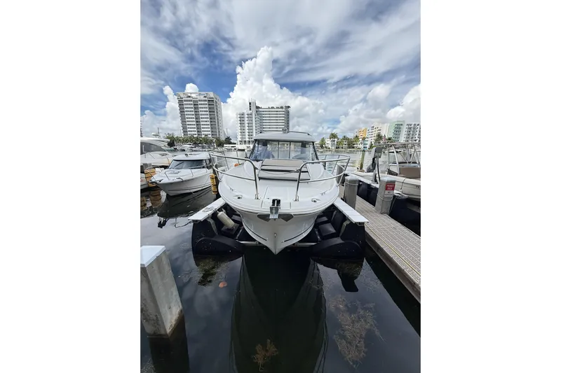  Yacht Photos Pics 2021 Jeanneau NC 895 boat docked at marina under cloudy sky.