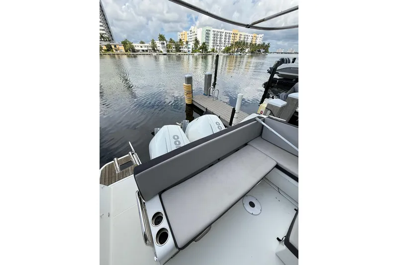  Yacht Photos Pics 2021 Jeanneau NC 895 boat with dual engines docked by waterfront buildings.