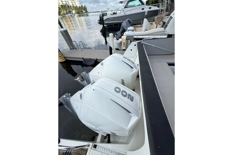  Yacht Photos Pics 2021 Jeanneau NC 895 with twin outboard engines docked at marina.
