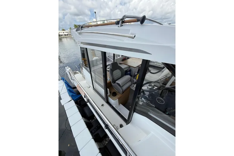  Yacht Photos Pics 2021 Jeanneau NC 895 boat docked, showcasing sleek design and spacious interior.