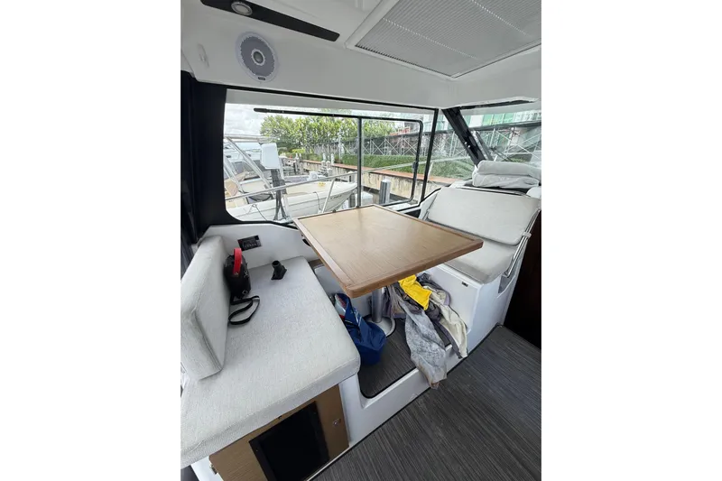  Yacht Photos Pics Interior of 2021 Jeanneau NC 895 boat with seating and table.