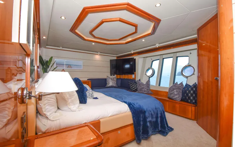  Yacht Photos Pics Luxurious bedroom interior of 2006 Ferretti Yachts 881 with elegant wood finishes.