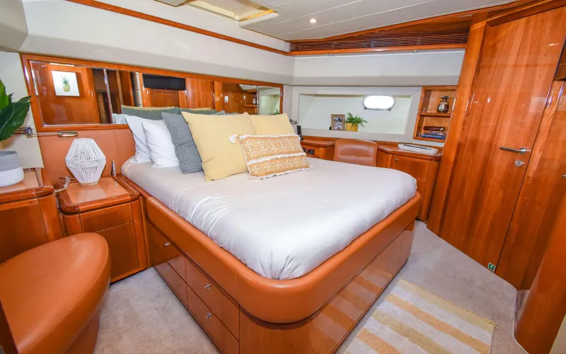  Yacht Photos Pics Luxurious 2006 Ferretti Yachts 881 bedroom with elegant wood finish and plush bedding.