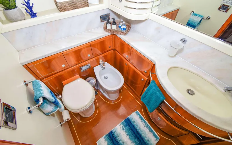 Yacht Photos Pics Luxurious bathroom in 2006 Ferretti Yachts 881, featuring elegant wood cabinetry and modern fixtures.