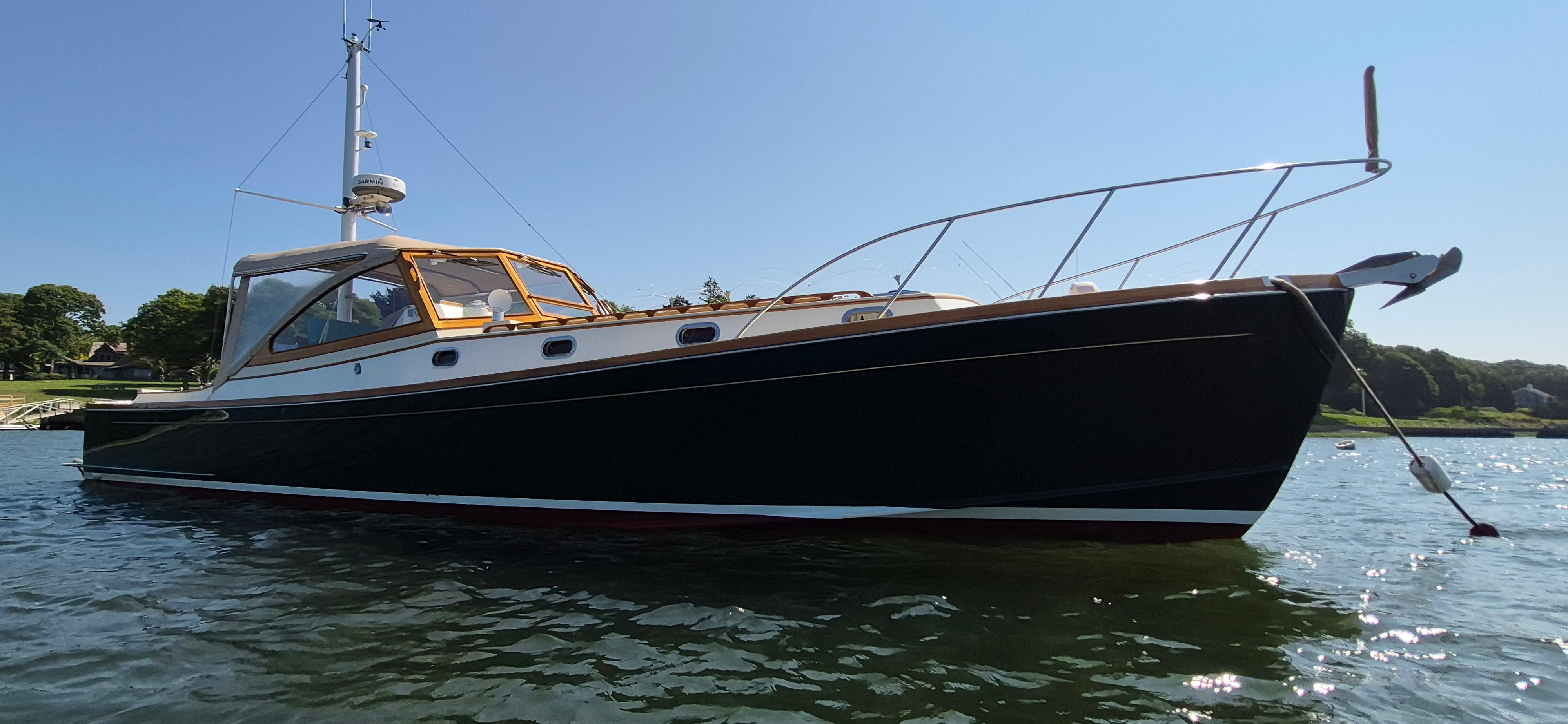 1997 Able 44 Downeast Express Cruiser on calm water, showcasing sleek design and craftsmanship.