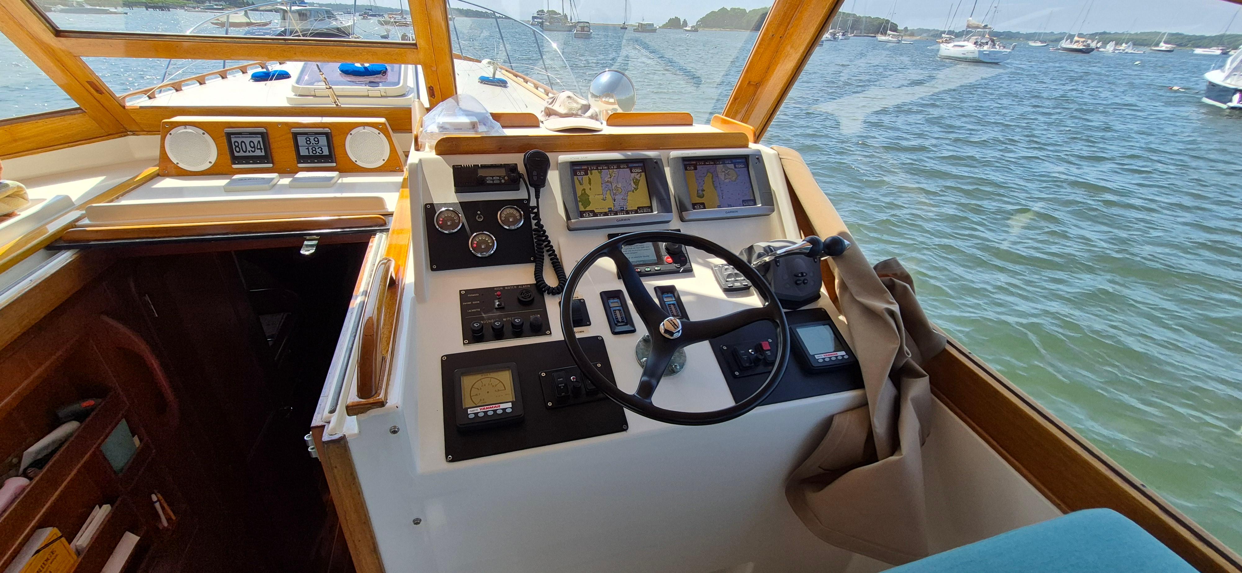 Interior view of 1997 Able 44 Downeast Express Cruiser helm with navigation equipment.