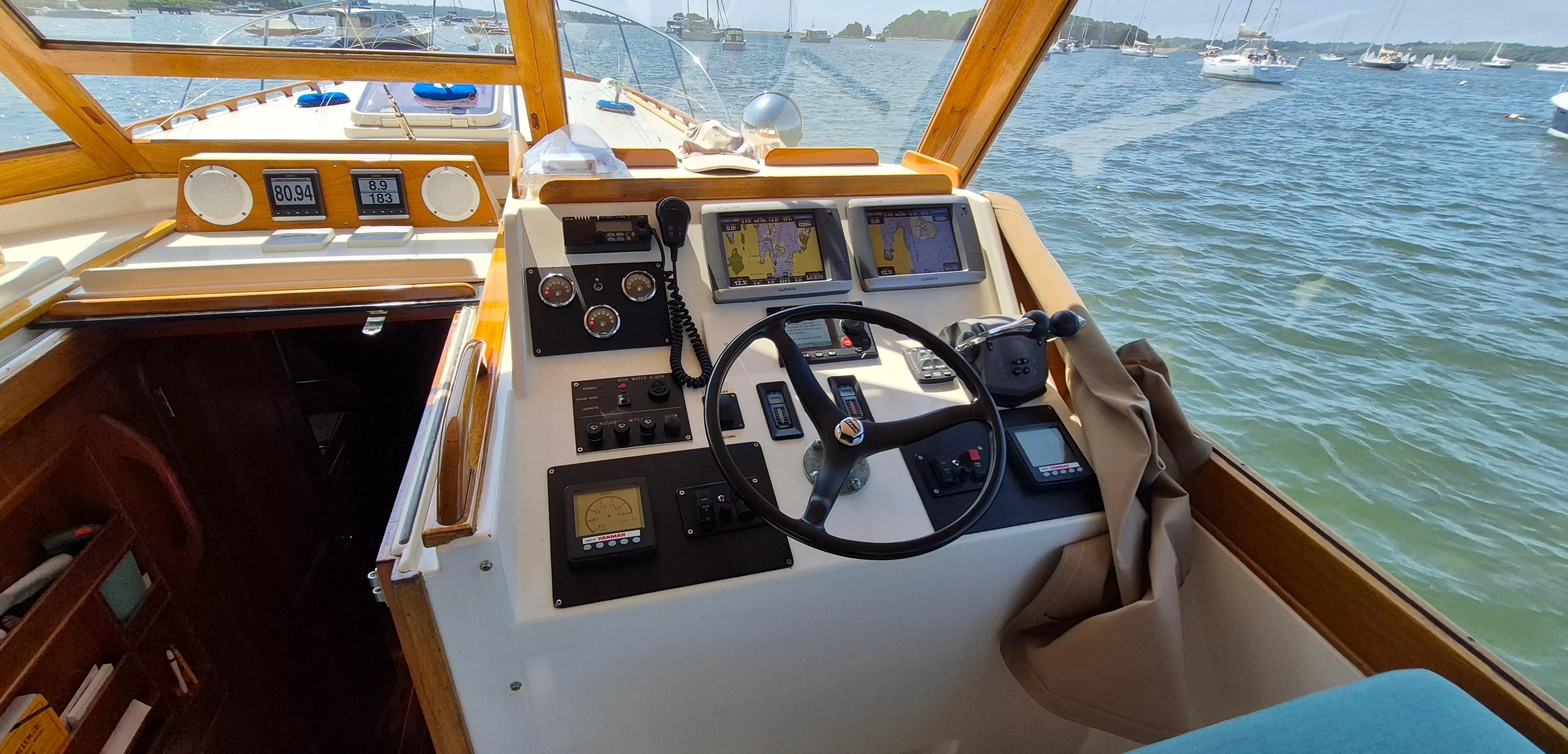 Interior view of 1997 Able 44 Downeast Express Cruiser helm with navigation equipment.