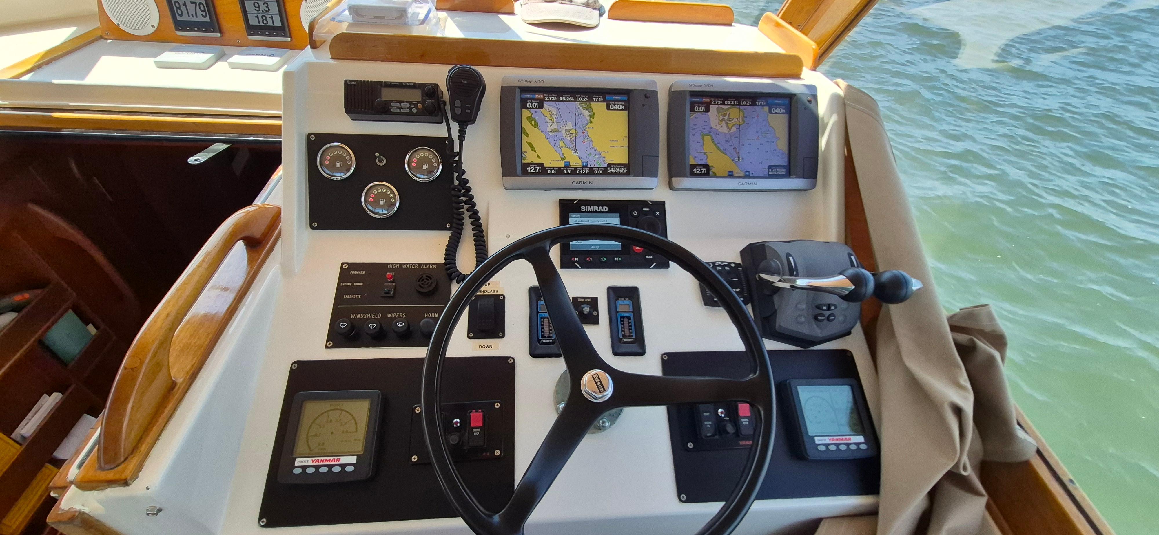 Helm of 1997 Able 44 Downeast Express Cruiser with navigation screens and controls.