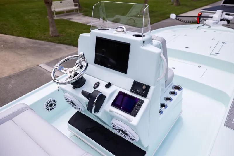  Yacht Photos Pics 2024 Yellowfin 24 CE boat console with steering wheel and electronic displays.