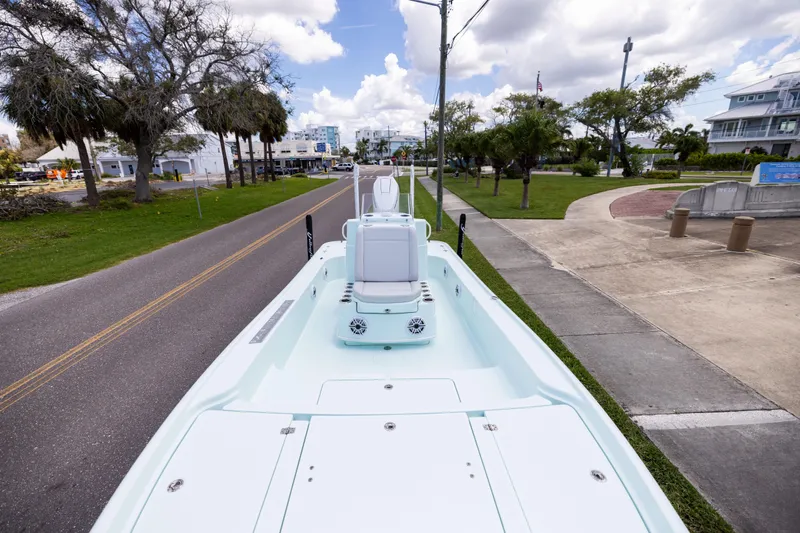  Yacht Photos Pics 2024 Yellowfin 24 CE boat on a road, showcasing sleek design and spacious deck.
