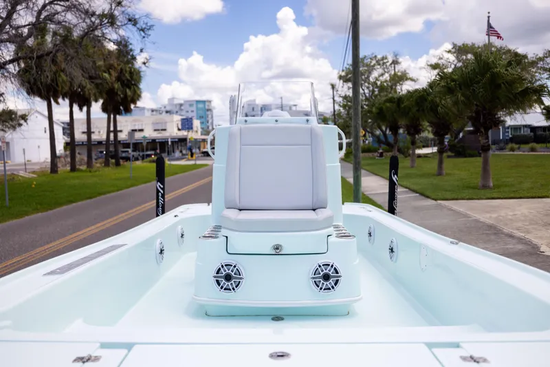  Yacht Photos Pics 2024 Yellowfin 24 CE boat interior with seating, speakers, and clear sky background.