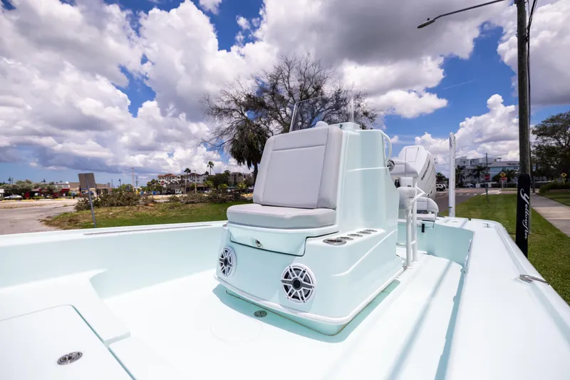  Yacht Photos Pics 2024 Yellowfin 24 CE boat with sleek seating and modern design under a cloudy sky.