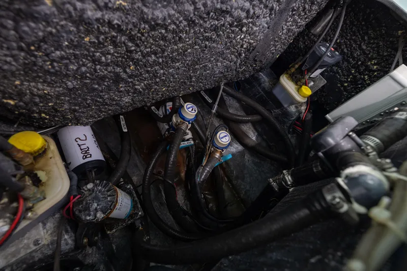  Yacht Photos Pics 2024 Yellowfin 24 CE boat engine compartment with hoses and components.