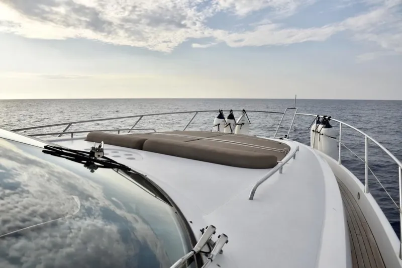  Yacht Photos Pics 2003 Sunseeker Manhattan 74 yacht deck with ocean view and cloudy sky.