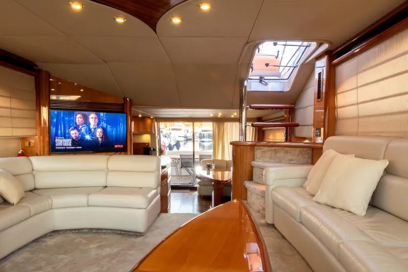  Yacht Photos Pics Luxurious interior of 2003 Sunseeker Manhattan 74 yacht with plush seating and entertainment system.