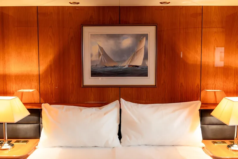  Yacht Photos Pics Luxurious cabin interior of 2003 Sunseeker Manhattan 74 yacht with elegant wood paneling.