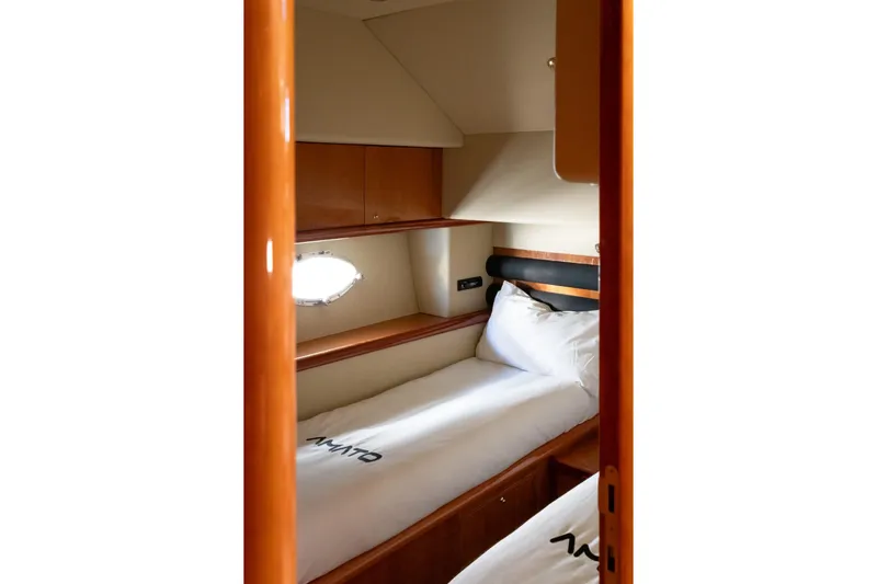  Yacht Photos Pics Cozy cabin interior of 2003 Sunseeker Manhattan 74 yacht with twin beds and porthole.