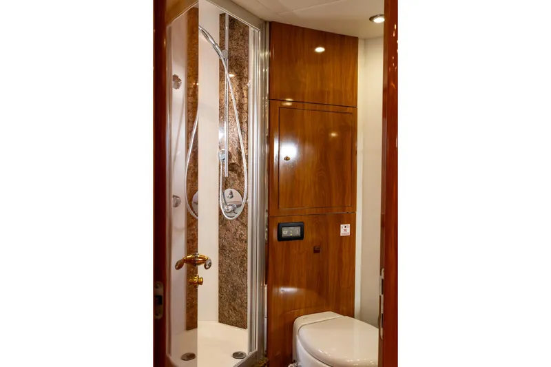  Yacht Photos Pics Luxurious bathroom in 2003 Sunseeker Manhattan 74 yacht with wood paneling and modern shower.