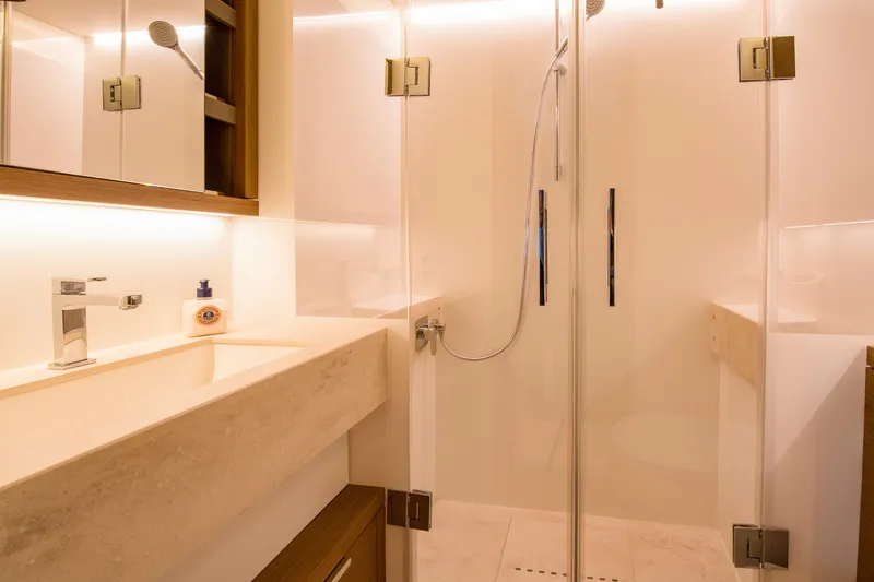 Mahe III Yacht Photos Pics Modern bathroom interior on 2023 Lagoon SIXTY 7 yacht, featuring sleek design and glass shower.