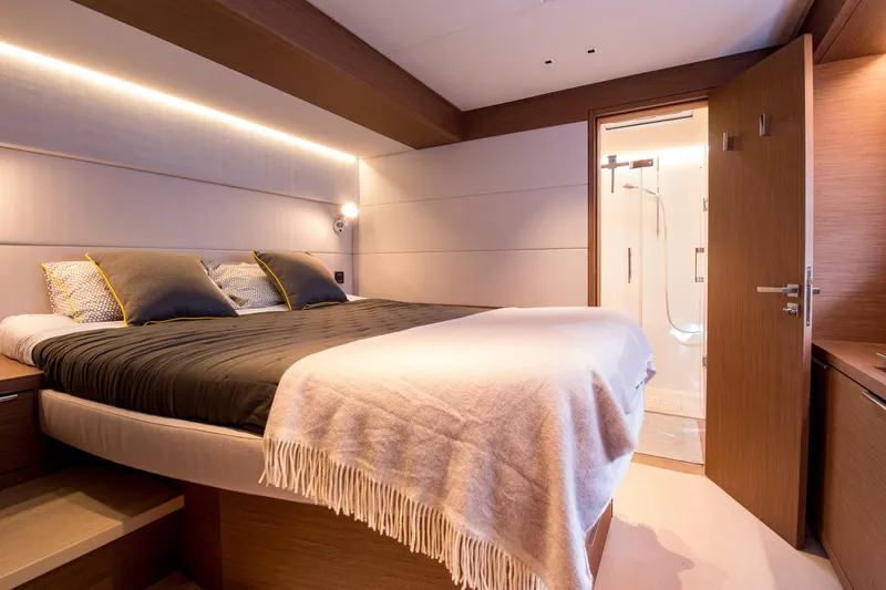 Mahe III Yacht Photos Pics Luxurious bedroom interior of 2023 Lagoon SIXTY 7 yacht with modern design and ensuite bathroom.