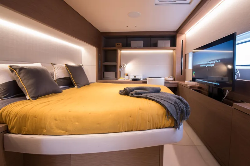 Mahe III Yacht Photos Pics Luxurious bedroom interior of 2023 Lagoon SIXTY 7 yacht with modern design and cozy ambiance.