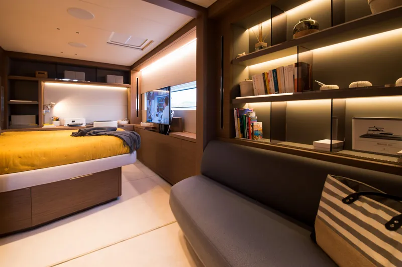 Mahe III Yacht Photos Pics Luxurious interior of 2023 Lagoon SIXTY 7 yacht with cozy bedroom and elegant shelving.