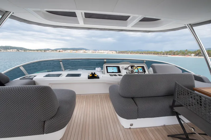 Mahe III Yacht Photos Pics Luxurious 2023 Lagoon SIXTY 7 yacht cockpit with plush seating and scenic ocean view.