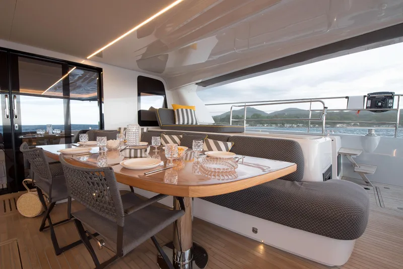Mahe III Yacht Photos Pics Luxurious dining area on 2023 Lagoon SIXTY 7 yacht with elegant table setting.