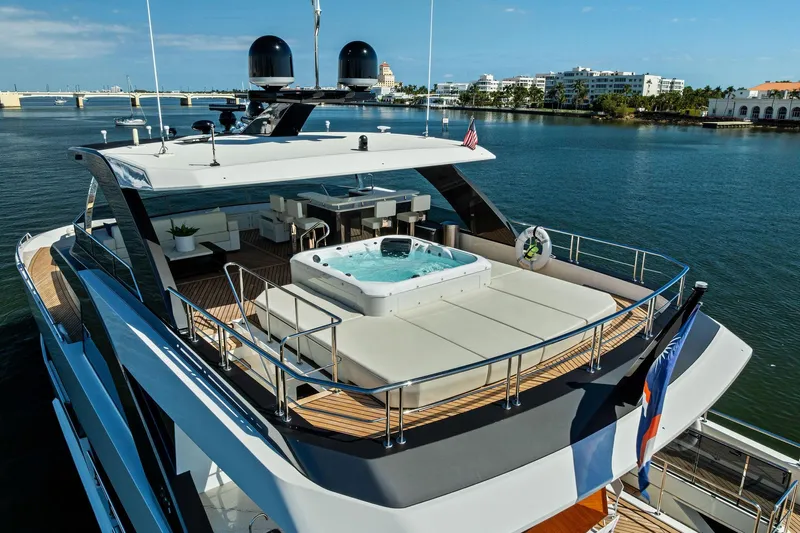 Serenity Now Yacht Photos Pics Luxurious 2024 Ocean Alexander 35 Revolution yacht with jacuzzi on deck, docked in scenic marina.