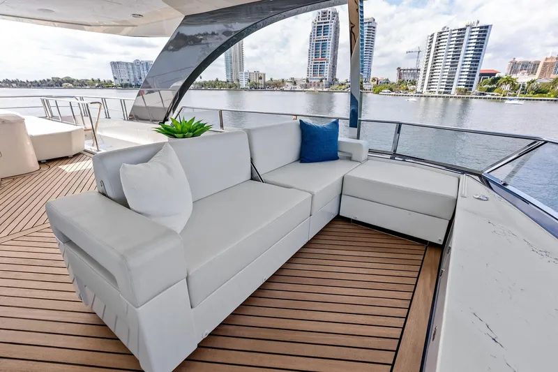 Serenity Now Yacht Photos Pics Luxurious seating on 2024 Ocean Alexander 35 Revolution yacht, with waterfront cityscape view.