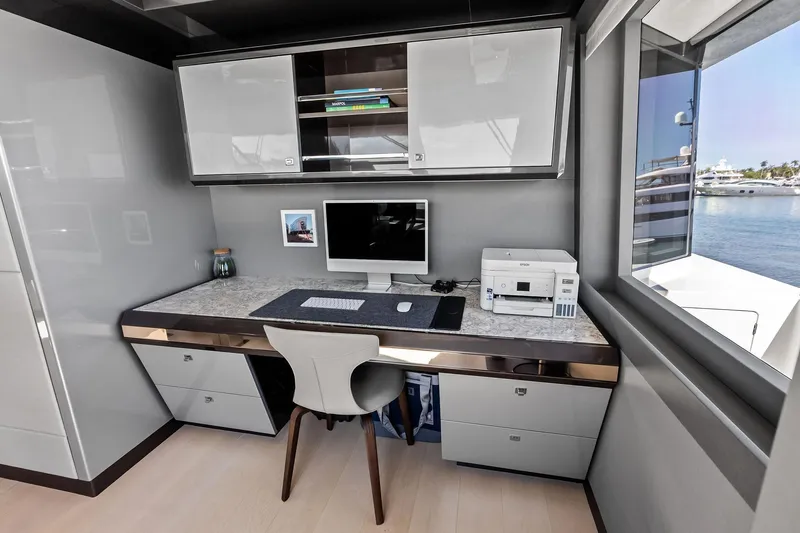 Serenity Now Yacht Photos Pics Modern office space on 2024 Ocean Alexander 35 Revolution yacht with desk, computer, and ocean view.