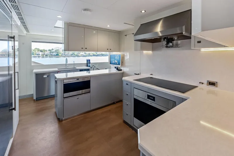 Serenity Now Yacht Photos Pics Modern kitchen interior on 2024 Ocean Alexander 35 Revolution yacht, featuring sleek appliances and spacious design.