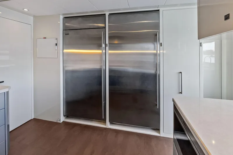 Serenity Now Yacht Photos Pics Modern kitchen interior on 2024 Ocean Alexander 35 Revolution yacht, featuring sleek stainless steel appliances.