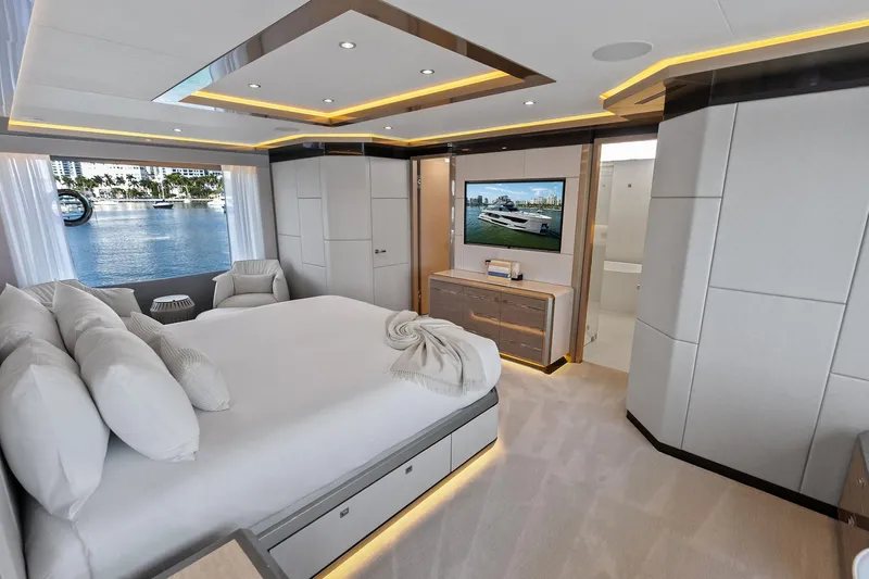 Serenity Now Yacht Photos Pics Luxurious bedroom interior of 2024 Ocean Alexander 35 Revolution yacht with waterfront view.