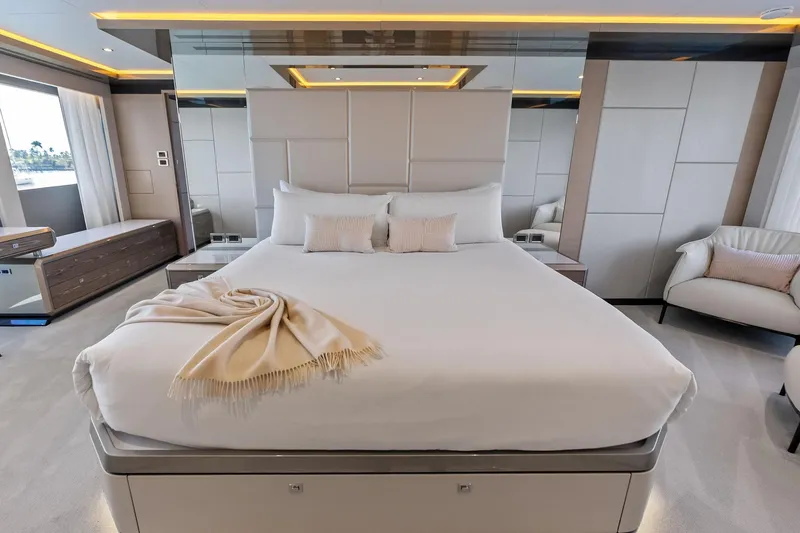 Serenity Now Yacht Photos Pics Luxurious bedroom interior of 2024 Ocean Alexander 35 Revolution yacht, featuring elegant design.