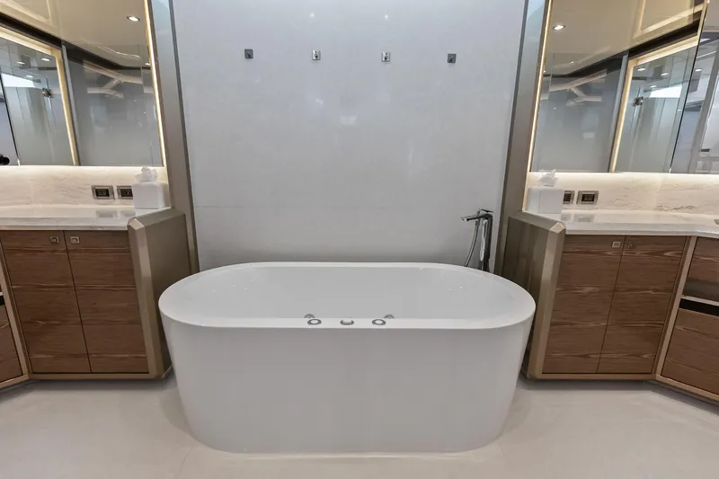 Serenity Now Yacht Photos Pics Luxurious bathroom in 2024 Ocean Alexander 35 Revolution yacht with modern bathtub and elegant design.