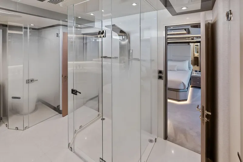 Serenity Now Yacht Photos Pics Luxurious interior of 2024 Ocean Alexander 35 Revolution yacht, featuring modern glass shower and elegant bedroom.