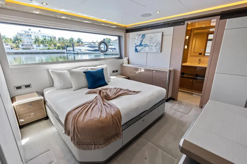 Serenity Now Yacht Photos Pics Luxurious bedroom interior of 2024 Ocean Alexander 35 Revolution yacht with waterfront view.