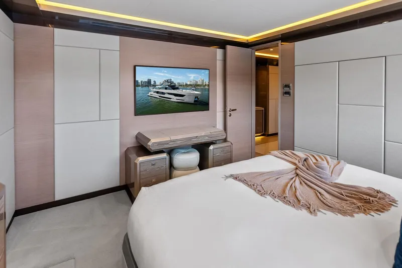 Serenity Now Yacht Photos Pics Luxurious bedroom interior of 2024 Ocean Alexander 35 Revolution yacht, featuring modern design elements.